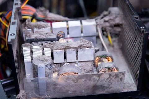 Dust accumulation inside a computer power supply unit during maintenance at a Stock Photos