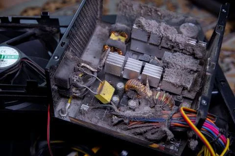 Dust accumulation inside an old computer power supply unit showing electronic Stock Photos