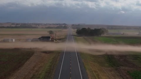 Dust blowing across an empty Oklahoma highway on a windy day with rural Stock-Footage 303348832