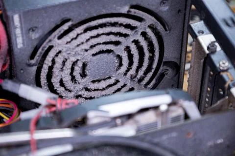Dust buildup inside a computer power supply unit reveals neglect in regular Stock Photos