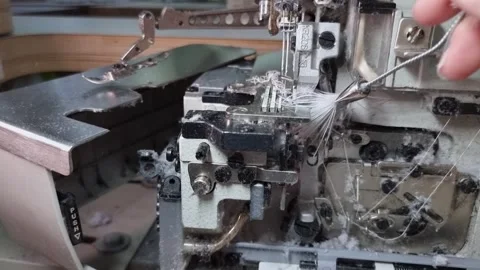 Dust cleaning of the overlock machine with a brush. Maintenance of sewing Stock Footage 317689521
