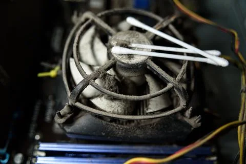 Dust on computer pc processor cooler with mainboard and computer case fragment. Stock Photos