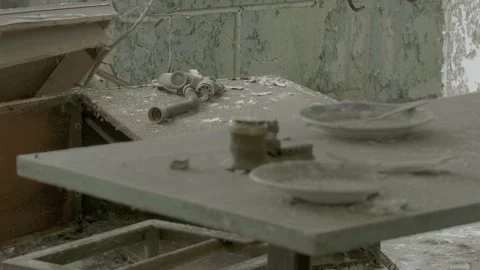 Dust-Covered Table with Broken Dishes and Primus Stove in an Abandoned Pripyat  Stock Footage 321291331