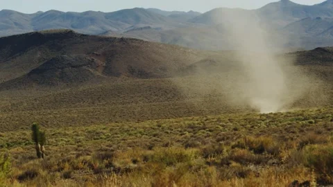 Dust devil churns furiously through the desert scrub. Stock Footage 234011929