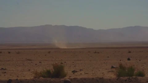 A dust devil moving across the desert on a hot day Stock Footage 307852869