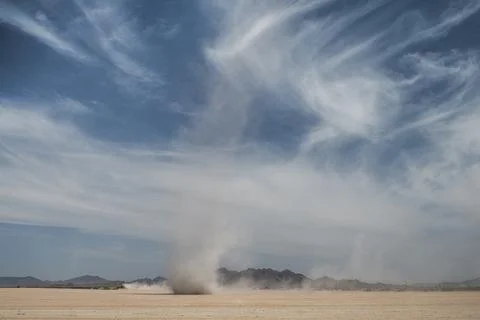 Dust devil stirred up in deserted field Stock Photos