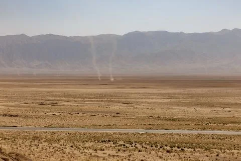 Dust devils spin across the hot, arid plain of Balkh Province, Afghanistan Stock Photos