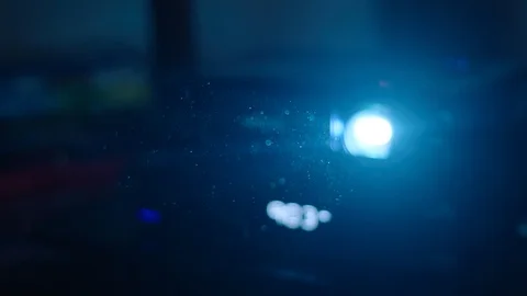 Dust floating in the air in front of projector light Stock Footage 106595050