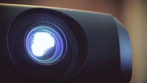 Dust particles are seen through a projector light beam Video stock 119426726