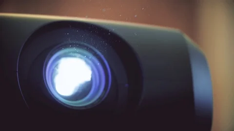 Dust particles are seen through a projector light beam 스톡 동영상 119426834