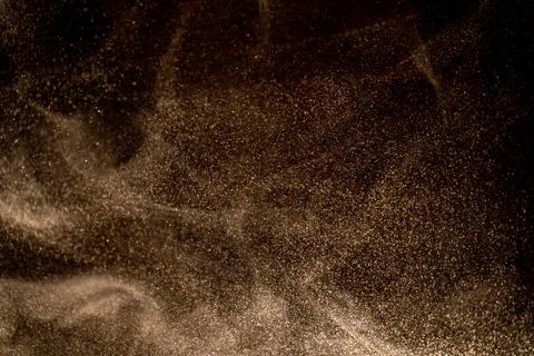 Dust particles cloud generating abstract shape on black background with copy Foto stock