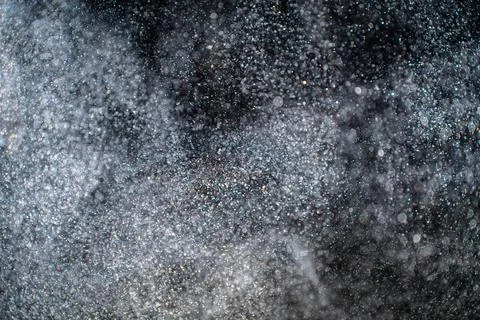 Dust particles cloud generating abstract shape on black background with copy Foto stock