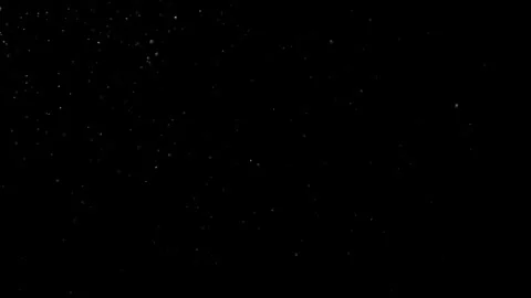 Dust Particles Floating In The Air Against A Dark Black Background. Stock Footage 302673145