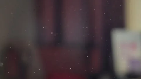 Dust particles floating and flying in the air in closed room as sun shines in Stock Footage 340820970