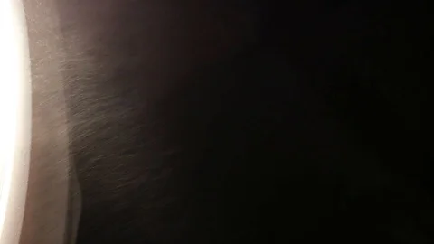 Dust Particles Flowing in Bright Light Black Background Stock Footage 99323902