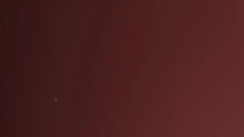 Dust Particles Fly In The Air Lingering Slowly Red Background Stock Footage 252805569