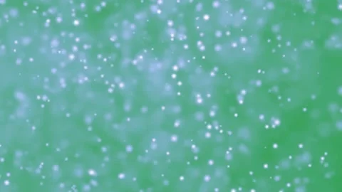 Dust particles motion graphics with green background Stock Footage 136871417