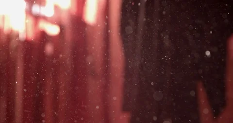 Dust particles moved around by light wind in a red room (Extreme close-up) Stock Footage 126018148