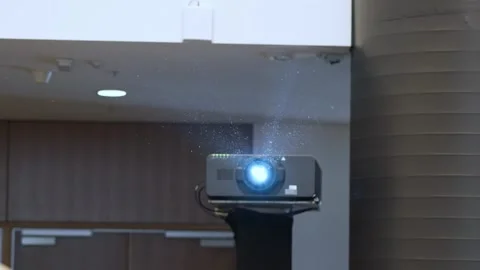 Dust Particles Seen On The Projector Lights Shining On The Screen At The Event Stock Footage 302275172