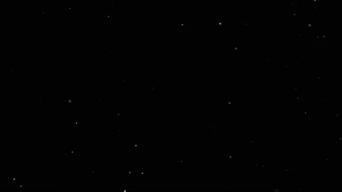 Dust particles sparkling on black background with white light bokeh effect Stock Footage 138100942