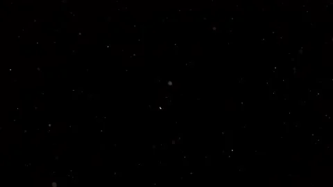 Dust particles sparkling on black background with white light bokeh effect Stock Footage 138101060