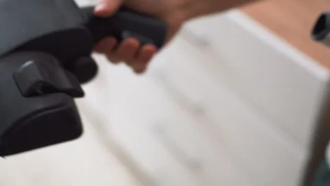 Dust removal along baseboards and cabinets. Carrying out routine cleaning with Stock Footage 337454810