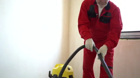 Dust removal with vacuum cleaner. A worker vacuums the floor with an industrial Stock Footage 163965612