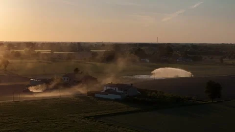 Dust from spring field work beside irrigation systems in Po Valley Italy drone Stock Footage 335966610