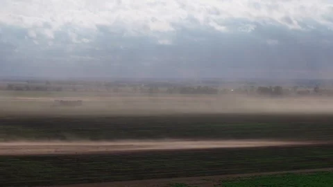 Dust storm on Oklahoma highway with wind blowing dust and vehicle passing by Stock Footage 303348586