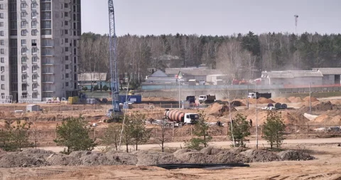Dust-Storm Trio: Three Dump Trucks Roaring Across a Vast Construction Site! Stock Footage 242034634