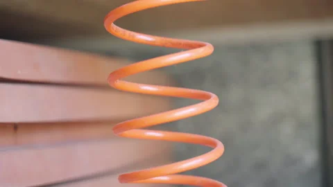 Dusted air compressor with spiral cable in workshop, machine with air pressure Stock Footage 316687589