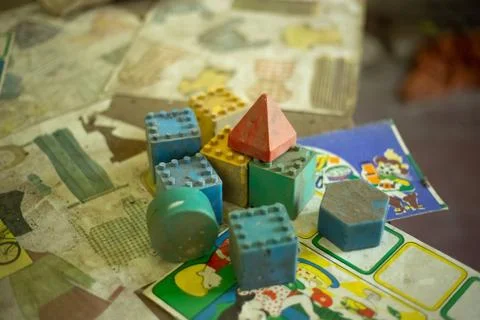 Dusted interlocking plastic bricks in the abandoned kindergarten Stock Photos
