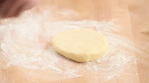 Dusting biscuit dough with flour and rolling it out Stock Footage 24662515