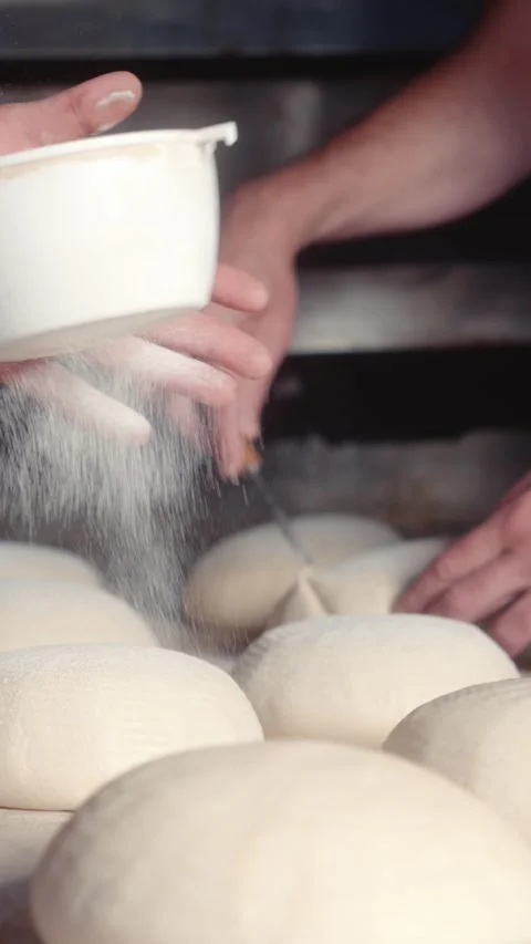 Dusting Bread Dough with Flour Using a Flour Shaker Stock Footage 344313062