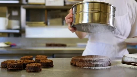 Dusting a cake Stock Footage 76728975