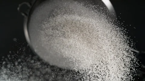 Dusting flour on black background. Slow Motion. Stock Footage 121478351