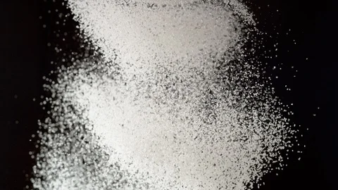 Dusting flour on black background. Slow Motion. Vidéo 128953887