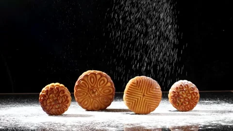 Dusting Flour over Traditional Chinese Mooncakes on Dark Background Stock Footage 340617074