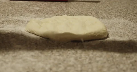 Dusting of flour on typical italian pizza dough - 4K DCI extreme slow motion Stock Footage 152152315