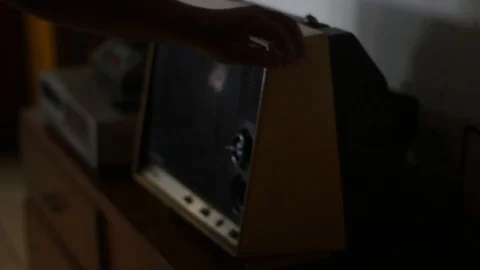 Dusting by hand on an old television Stock Footage 122491007