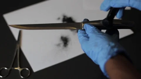 Dusting a knife for prints Stock Footage 79339561