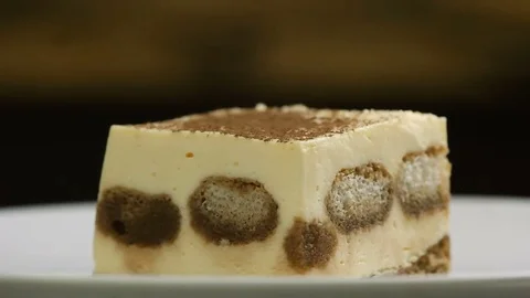 Dusting tiramisu cake by powdered cocoa Stock Footage 77749464
