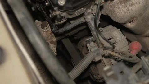 A dusty car alternator mounted inside an engine compartment. Stock Footage 342262145