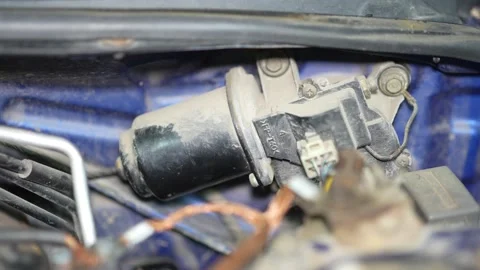 A dusty car windshield wiper motor installed on the firewall. 動画素材 345910593