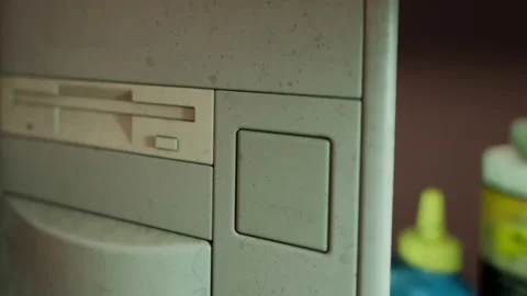Dusty computer component on a desk with bottles in background Stock Footage 343930207