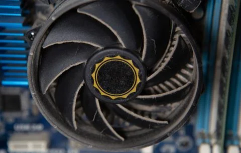 A dusty cooling fan computer circuit Board. Concept of broken computer parts Stock Photos