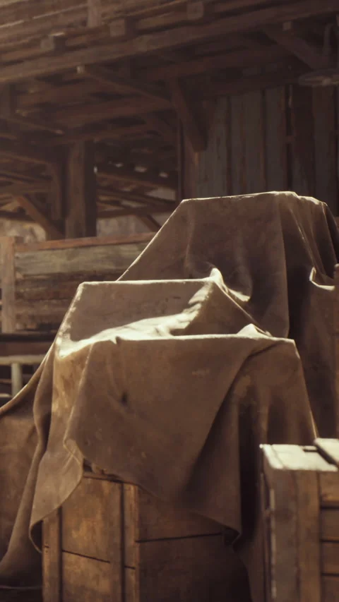 Dusty crates covered with tarps in an old warehouse near sunset Stock Footage 339040039