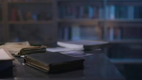 Dusty documents and scattered papers reveal secrets in a quiet library Stock Footage 318703815