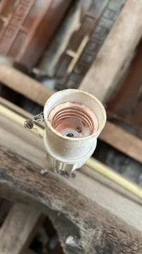 Dusty Light Bulb Socket with Cobwebs in Abandoned Building Foto stock