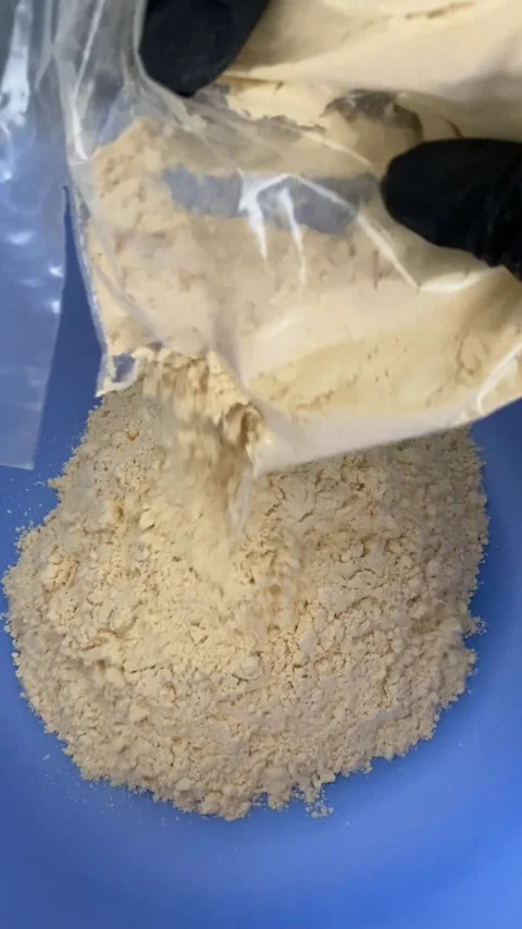 Dusty Material Pouring into Blue Container with Plastic Bag Sitting Nearby Stock Footage 333306274